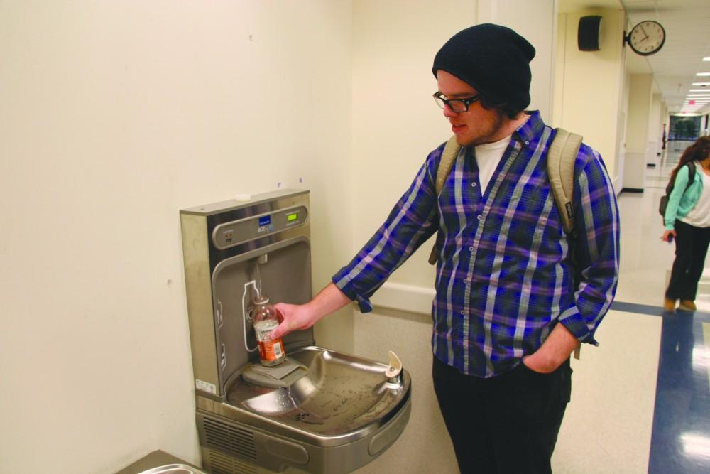 GVL/ Dylan Graham
GVSU student Damon Graham fills his empty water bottle at the the new water-bottle refilling station located in Mackinac.