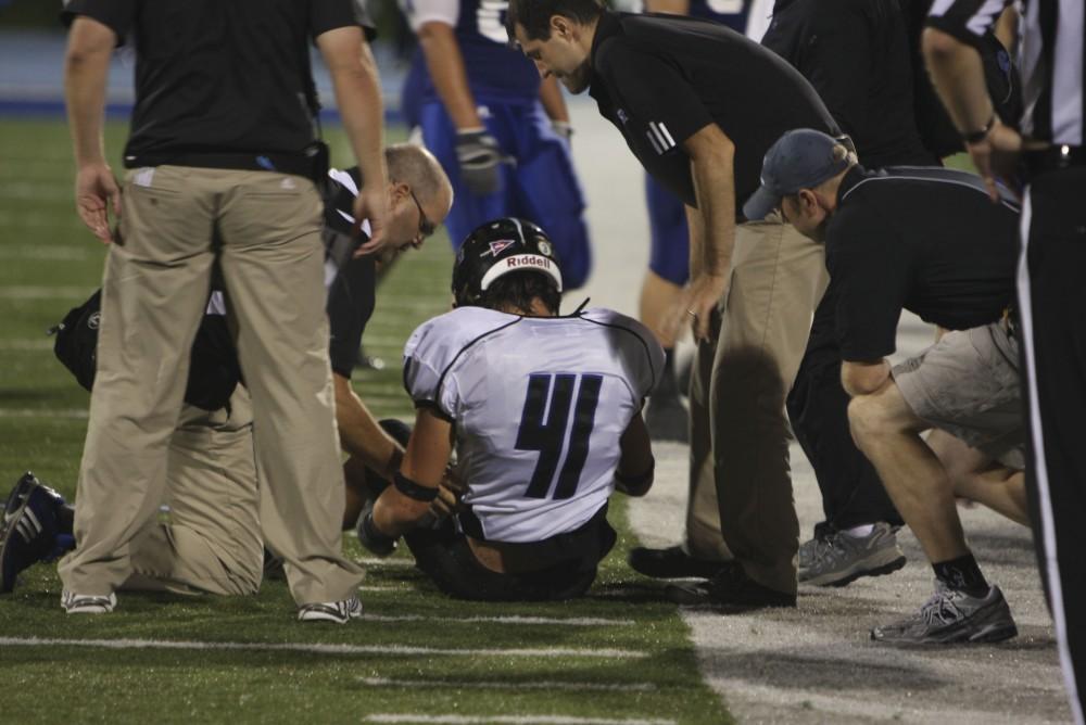 GVL/ Brady Frederickson
Sophomore linebacker Zach Galloway is checked over after his injury during their away game against Hillsdale on Saturday.