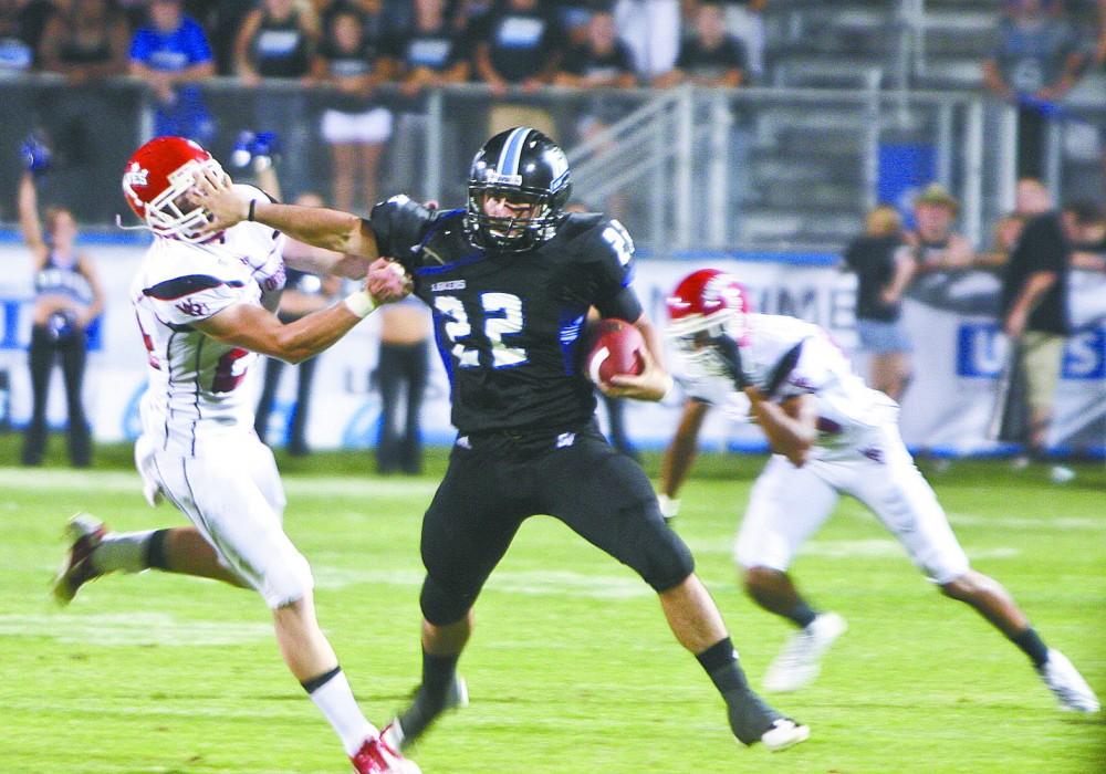 GVL / Nathan Mehmed
Sophomore running back Michael Ratay fights off a Western Oregon defenseman