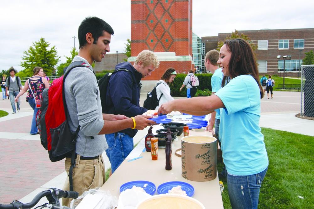 GVL/ Andrea Baker
Alexis Godush hands out ice cream to a student during the Future Alumni Association Ice Cream Social.