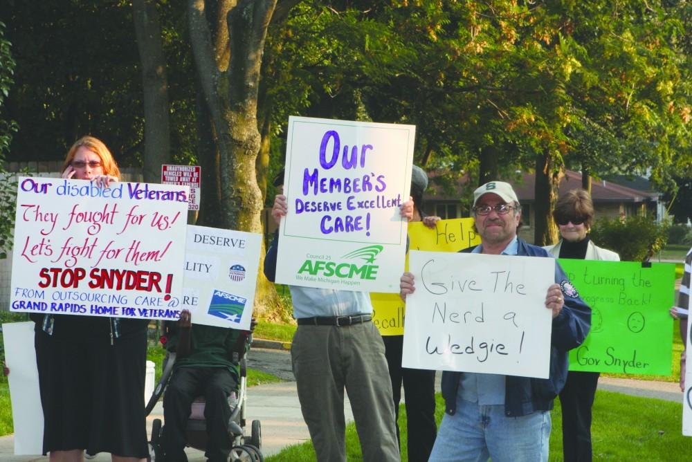 GVL/ Eric Coulter
Protesters at the Town Hall Meeting in Grand Rapids on Tuesday.