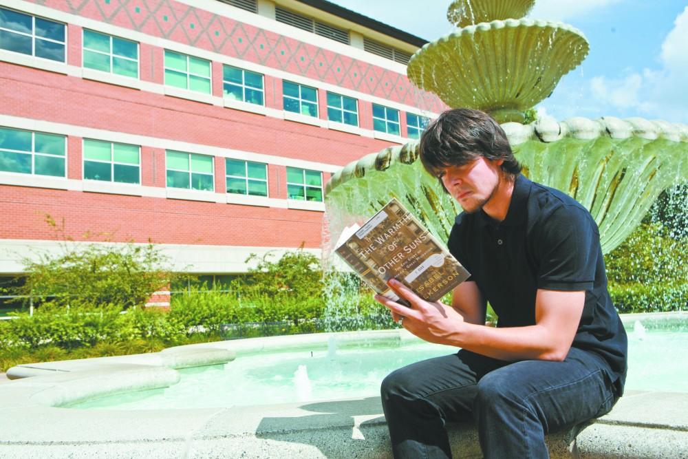 GVL / Eric Coulter
Grand Valley State University student Guillaume Dusseux reads The Warmth of Other Suns by Isabel Wilkerson. Wilkersons novel is this yearss community reading project. 