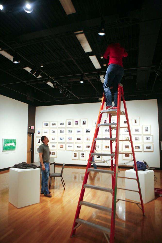 GVL / Eric Coulter
Paris Tennenhouse, the GVSU Art Gallery Exhibit Designer, adjust the lighting as John Klote, Assistant Proprietor, instructs what needs to be done. The pair is preparing for the Argentina Contemporary Art exhibit which has its reception on Thursday