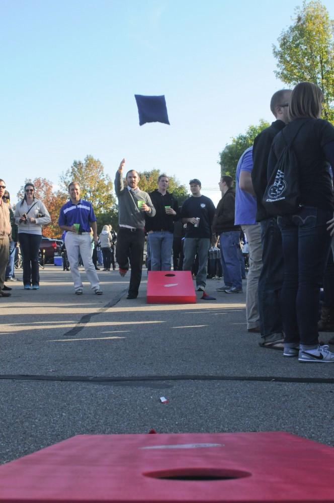 GVL / Eric Coulter
GVSU Senior Cain Larkins shows perfect form while playing corn hole at the Laker tailgate.