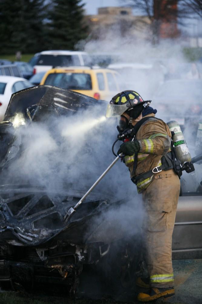 GVL / Eric Coulter
Allendale Fire FIghters responded to a car fire that took place in the parking lot near the Fieldhouse. Grand Valley State Police were unavailable for comment as to the cause of the fire. 