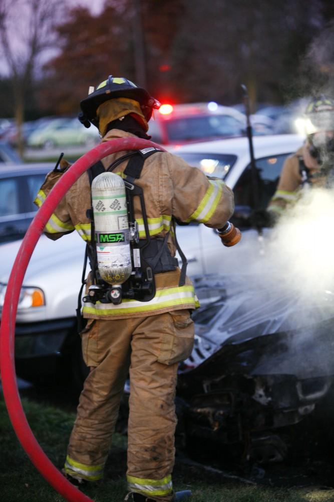 GVL / Eric Coulter
Allendale Fire FIghters responded to a car fire that took place in the parking lot near the Fieldhouse. Grand Valley State Police were unavailable for comment as to the cause of the fire. 