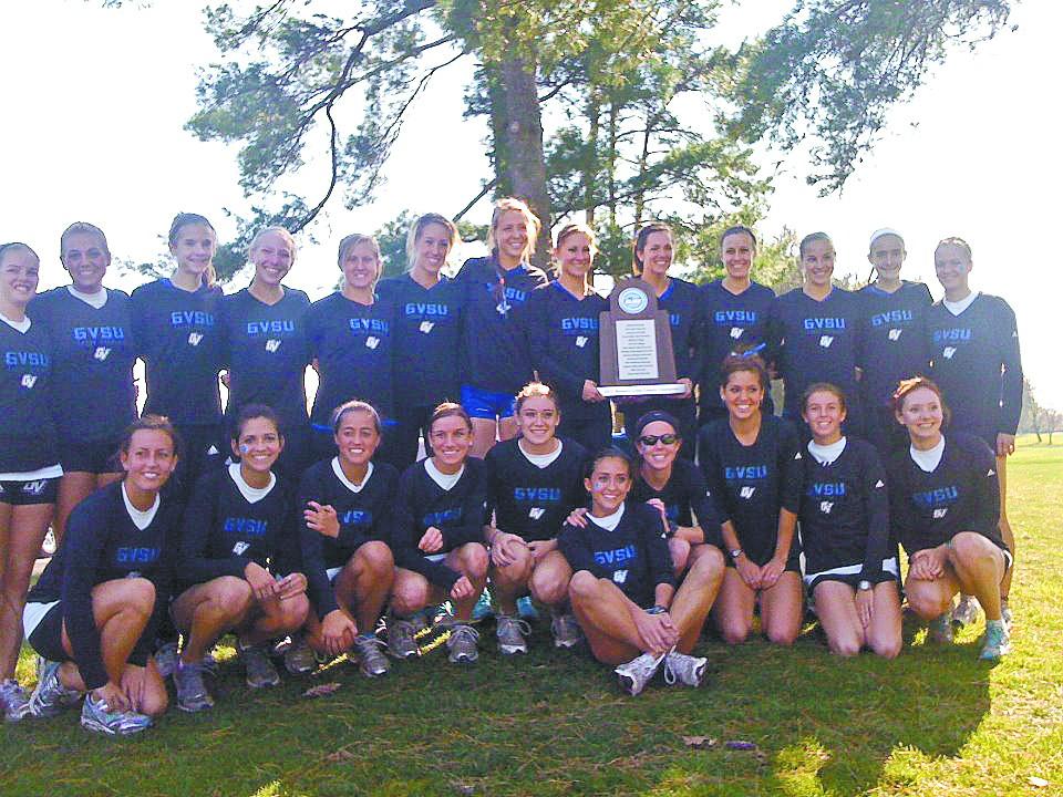 Courtesy Photo / GVSU Cross CountryThe Womens cross country team hold up their GLIAC Championship trophy