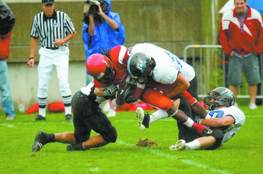 GVL Archive
Zach Breen pulls down a SVSU offenseman with the help of teammates during a past match. This year's game will be held at Lubber's Stadium at 1pm this Saturday