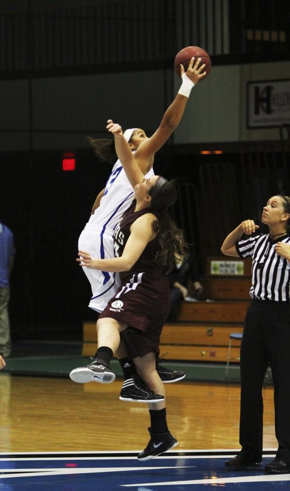 GVL / Robert Mathews / Brittany Taylor (13) winning the tip off against Aquinas.