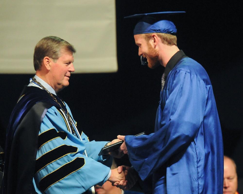 GVL / Eric Coulter
Graduate Tyler Hammersma accepts his diploma from President Haas during commencement