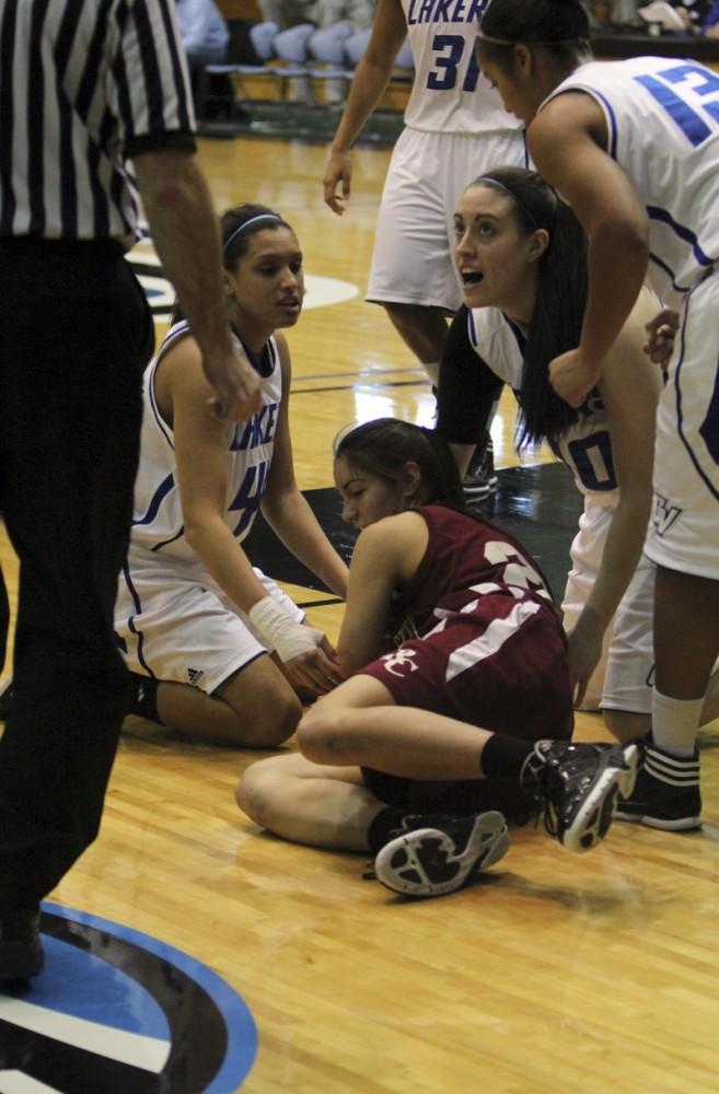 GVL / Robert Mathews / Two Lakers look to the ref for the call on a loose ball. 