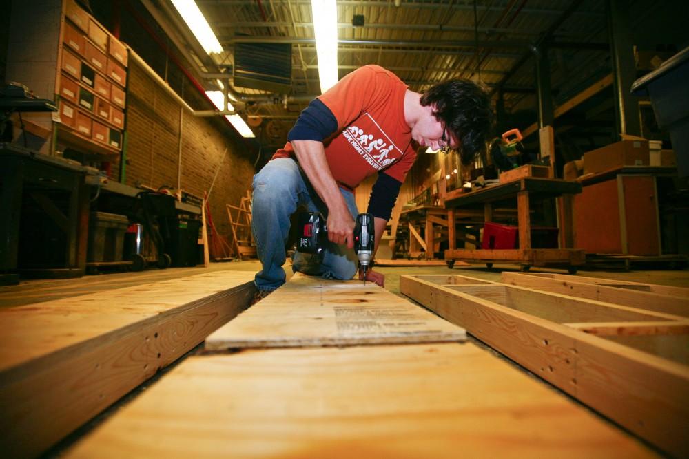 GVL / Eric Coulter
Senior Joe Cox works on a set in the scene shop behind the stage in the Louis Armstrong Auditorium