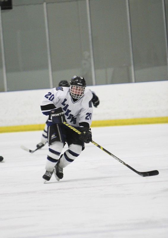 GVL / Robert Mathews
Forward Matt Smartt (20) races the puck up the ice against Oakland University. 