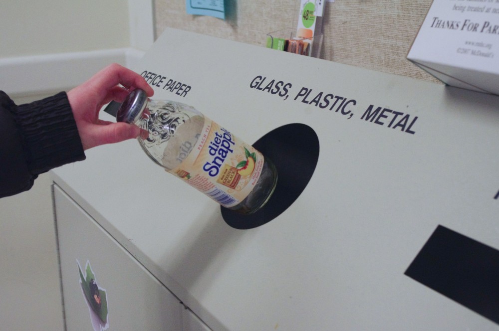 GVL / Amalia Heichelbech
Grand Valley student Charity Acton recycling a bottle
