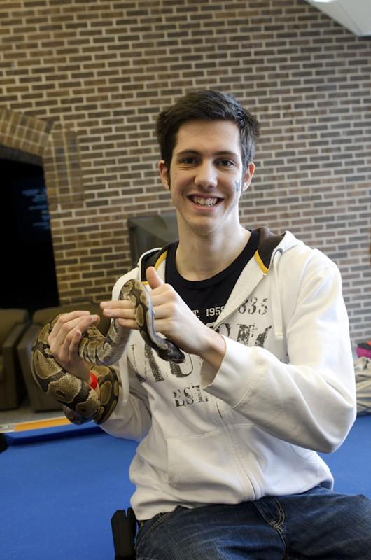 GVL / Bo Anderson
Jeremy Podlaski holds a snake while visiting his sisters Megan and Kim during Sibs and Kids Weekend.