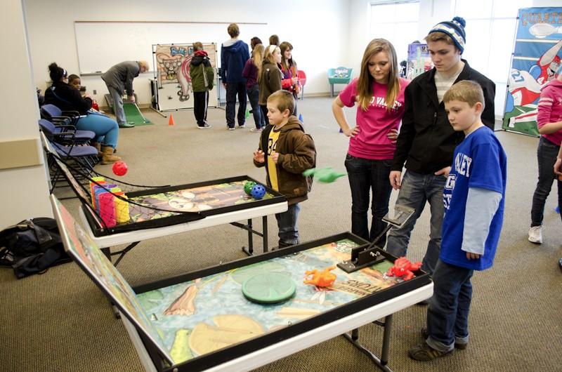 GVL / Bo Anderson
Steven Northup-Smith and his sister Kylie watch as their brother Brandon plays a game on Saturday during Sibs and Kids Weekend.