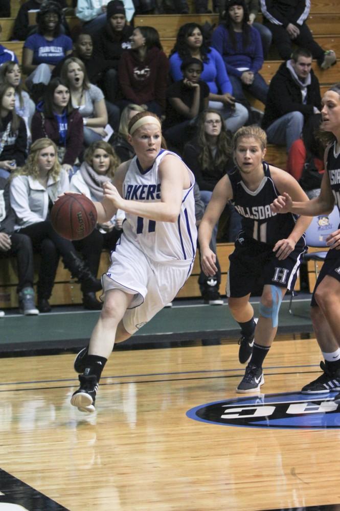 GVL / Robert Mathews
Guard Breanna Kellogg (11) drives past a Hillsdale player during Saturday nights game. 