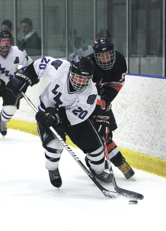GVL / Eric Coulter
Freshman Matt Smartt (20) shooting the puck away from a defender during the Lakers last game against Hope College