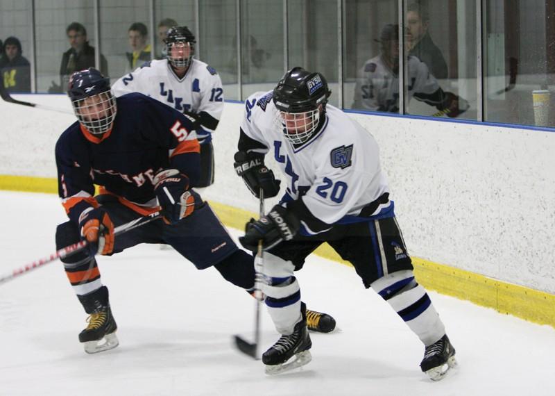 GVL / Eric Coulter
Freshman Matt Smartt (20) shooting the puck away from a defender during the Lakers last game against Hope College