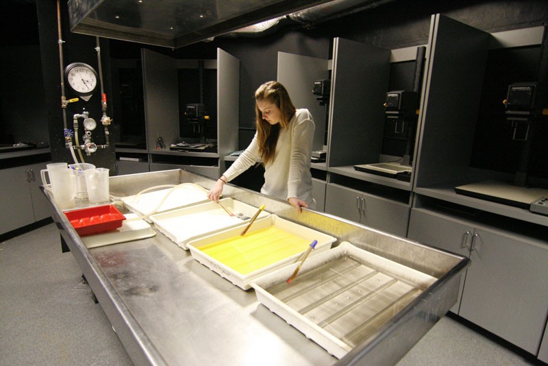 GVL / Andrea Baker

Art and photography student Blaire Bancroft hard at work in the gang darkroom located in Lake Superior Hall. The chemical waste is disposed according to standards