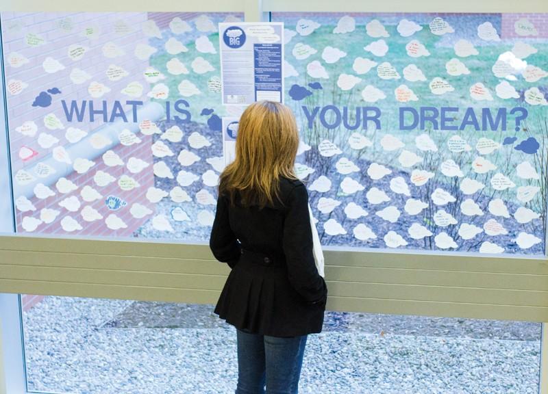 GVL / Bo Anderson

GVSU Junior Kristen Wellman looks at the Dream BIG display in Niemeyer. The Office of Fellowships Dream BIG campaign encouraged students to display their dreams on the clouds displayed.