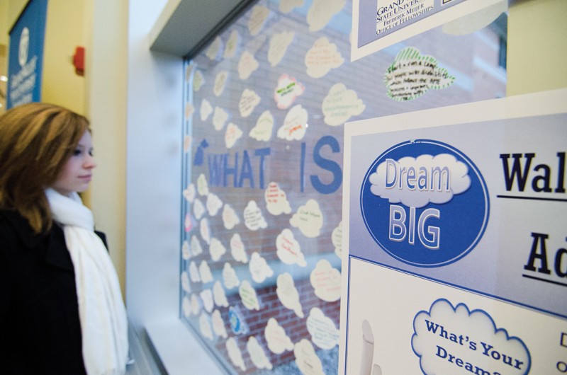 GVL / Bo Anderson

GVSU Junior Kristen Wellman looks at the Dream BIG display in Niemeyer. The Office of Fellowships Dream BIG campaign encouraged students to display their dreams on the clouds displayed.