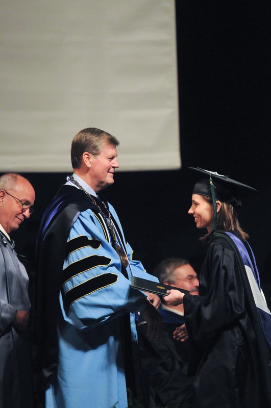 GVL Archive 
President Haas offers a diploma to a graduate during commencement 