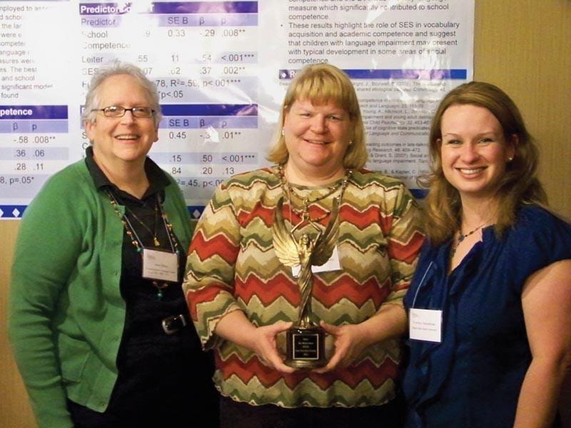 Courtesy Photo / Nate Hoekstra
Jean Silbar, Beth Macauley and Courtney Karasinski have their turns holding the M&M trophy.