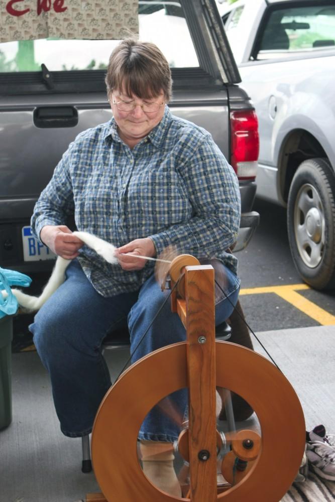 GVL / Eric Coulter
Sue Carpenter of Sassy Ewe located in Barryton, Michigan spins wool into yarn at the Fulton Street Farmers Market. Carpenter sells this yarn and also products she makes from it. 