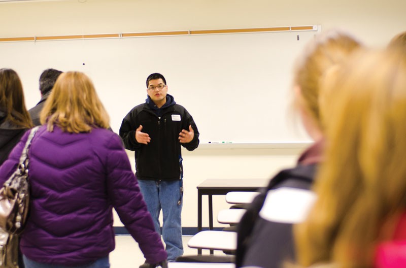 GVL / ArchiveGVSU student Patrick Brown leads a tour group around campus.