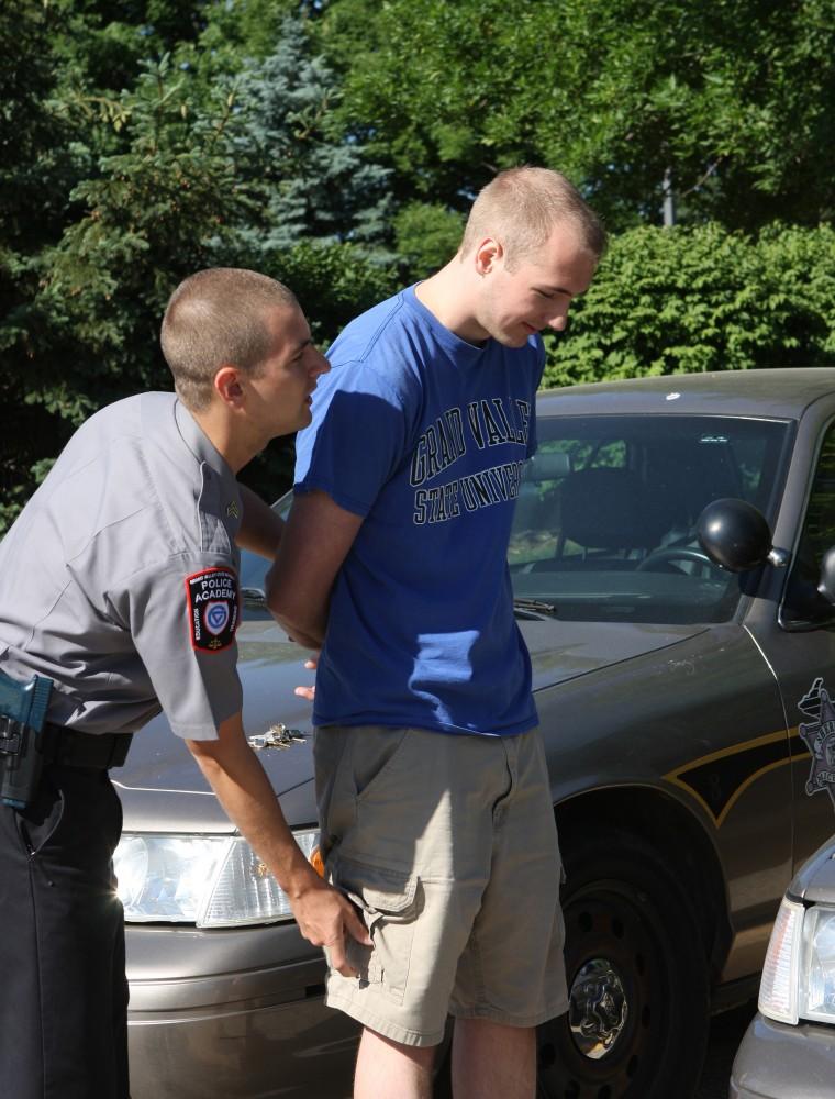 GVL / Eric Coulter
Police Academy Recruit Nick Soley searches a volunteer during a training session. 