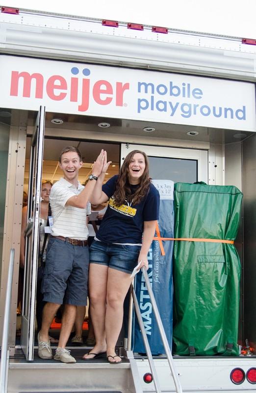 GVL/Bo Anderson GVSU students Jessica Hollenbeck and Colin Kammeraad exit the Meijer Mobile Playground during Meijer Mania.