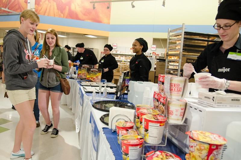 GVL/Bo Anderson GVSU Freshman Kaela Pickens samples the free food during Meijer Mania.