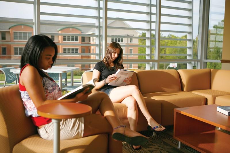 GVL / Eric CoulterStudents Kayla Campbell and Stephanie Mehmed work in the common area of the South Apartment C dorm on campus. Due to the large number of incoming freshman, an overflow in the dorms has cased some freshmen to be housed in Laker Village. 