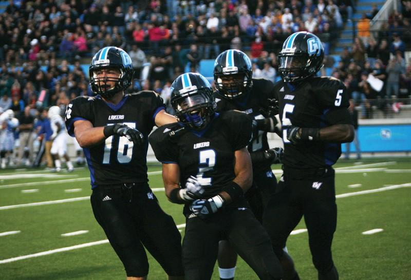 GVL / Robert Mathews 
Junior corner back Reggie Williams (2) and teammates celebrating after a touchdown.