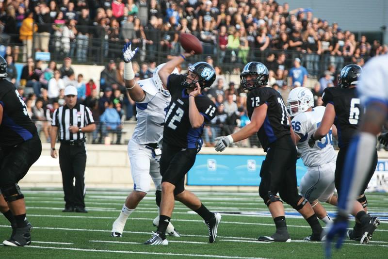 GVL / Robert Mathews
Junior Quarterback Heath Parling (12) throwing the ball past a blitzing defender. 