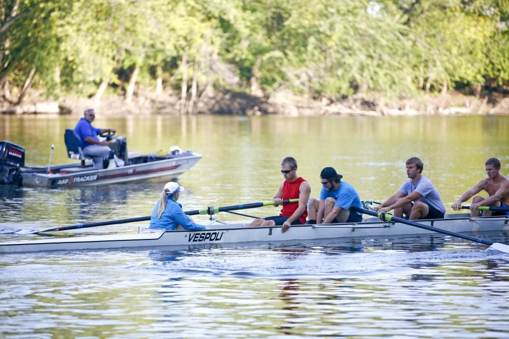 GVL / Eric CoulterA coxed four rows onto the Grand River under the watchful eye of Head Rowing Coach John Bancheri