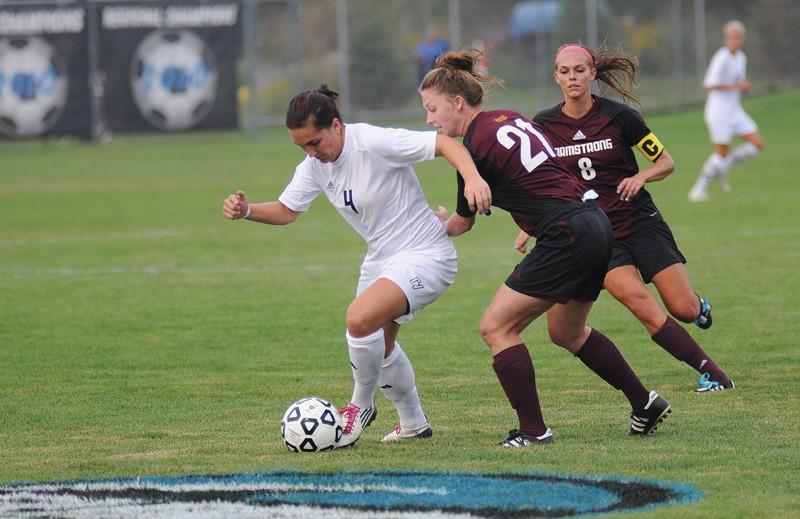 GVL / Eric Coulter Senior Erin Hilbert taking the ball up the field past a Saginaw Valley State defender. 