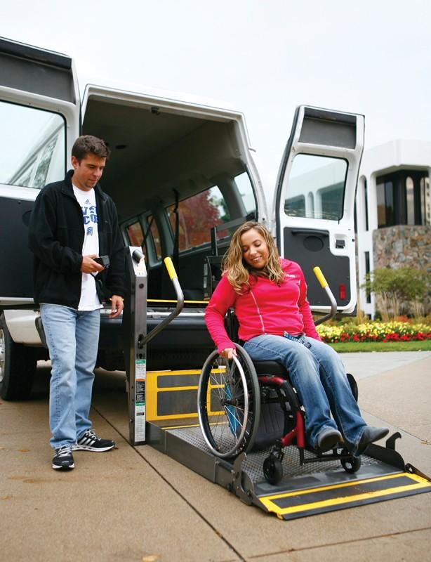 GVL / Eric CoulterJoe Miller from Disability Support Resources assists Stephanie Deible get around campus