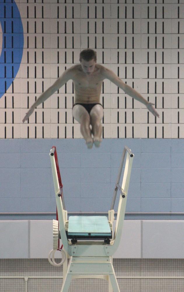 GVL / Eric CoulterTaking the Leap: Freshman diver Ben Cornillie dives during Fridays meet. 