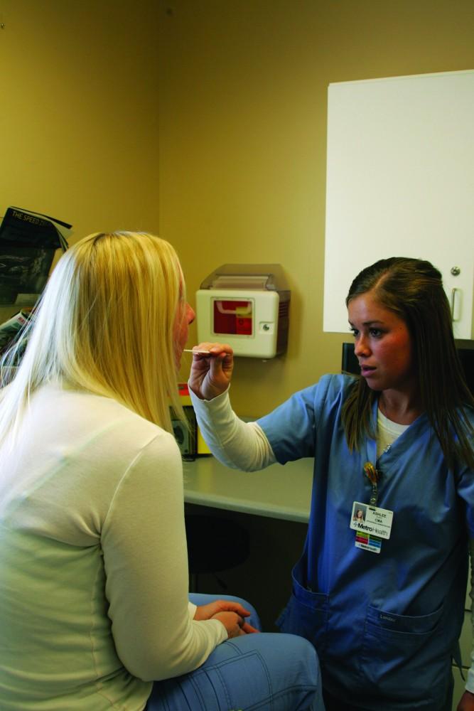 GVL / Amy HammondStudent nurse Ashlee Olsen checks out a patient in the Health Services Building.