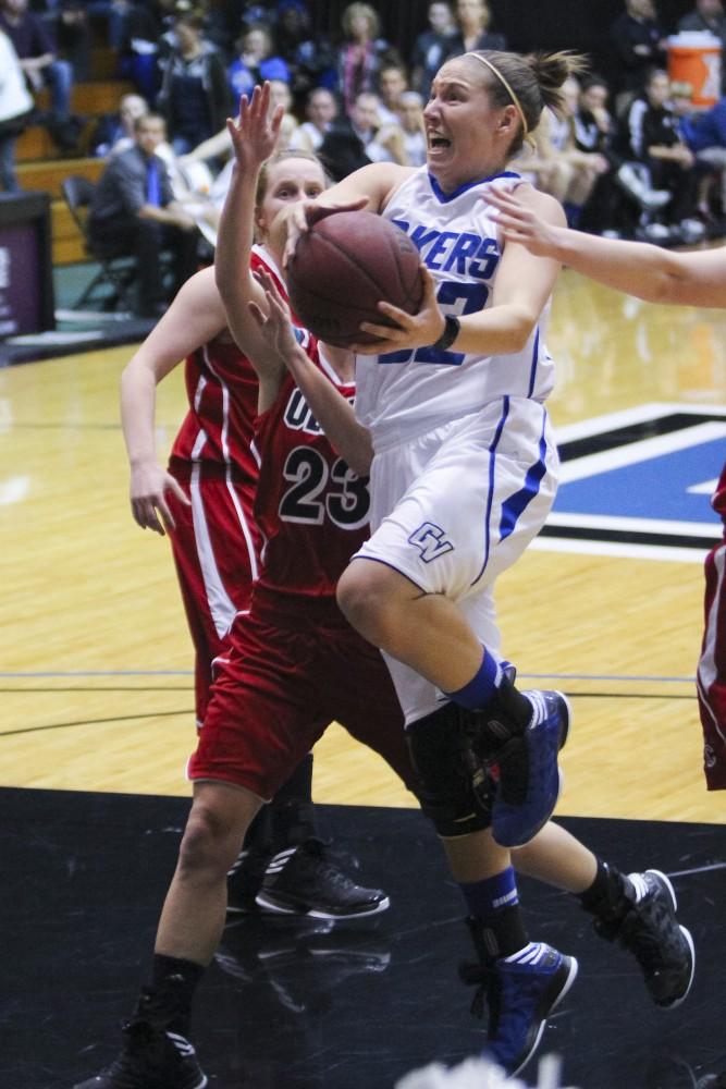 GVL / Jessica Hollenbeck

Senior Lauren Stodola pushes her way through Olivets defenders for a Laker basket.