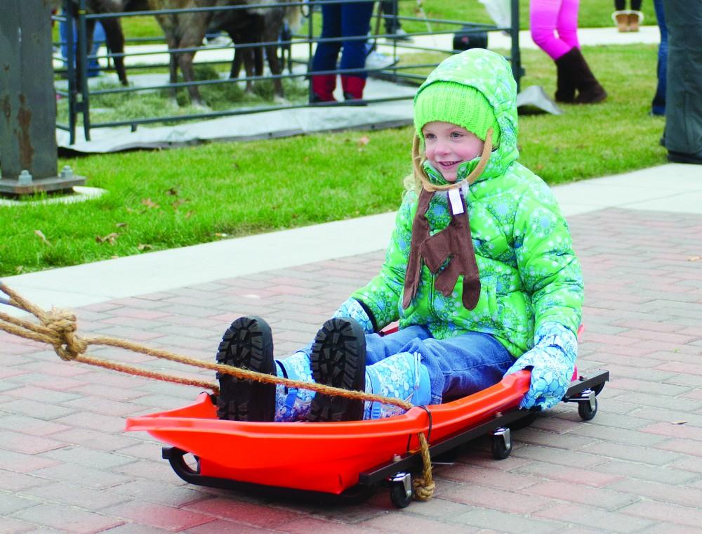 GVL/Bo AndersonLauren Perni, age 4, enjoys a sleigh ride during the first annual GVSU Reindeer games.