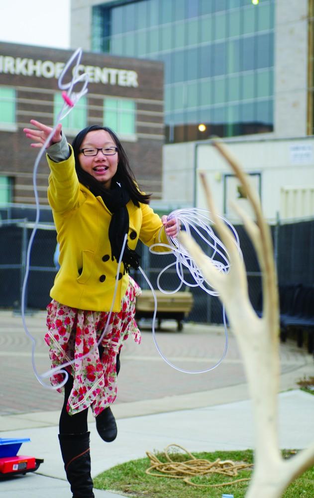GVL/Bo Anderson

Xinyi Ou tries her hand at the reindeer ring toss at the first annual GVSU Arctic Games.