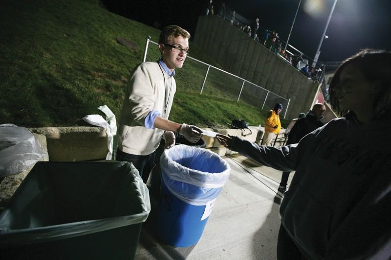 GVL / ArchiveJunior GVSU student, John Gezon, assisting in the Zero Waste program during the football game. 