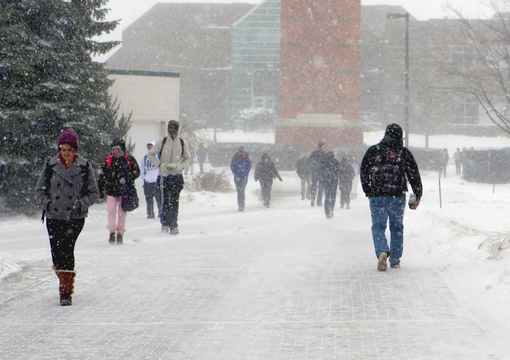 	Students tuck their heads down to avoid the harsh winter weather on Grand Valley State University’s Allendale campus 