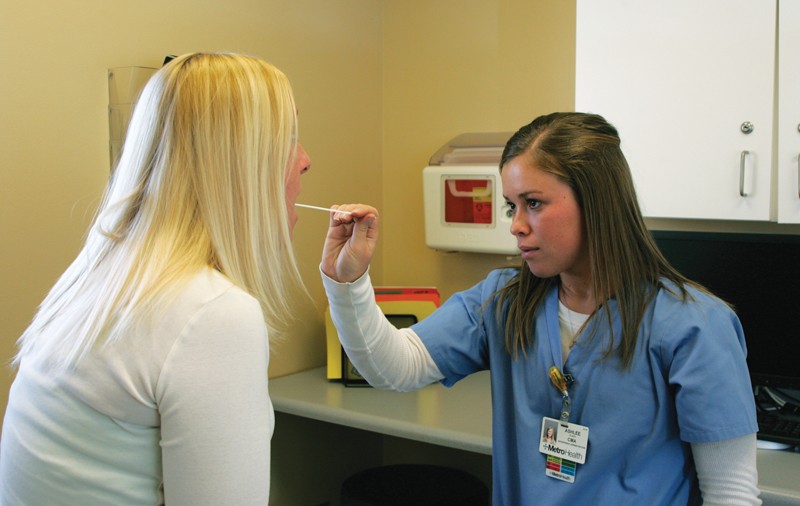 GVL / ArchiveStudent nurse Ashlee Olsen checks out a patient in the Health Services Building.