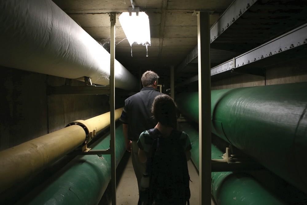 GVL / Robert Mathews
Rence Meredith, Assistant Maintenance Supervisor for Facility Services, describes the roles of the pipes located throughout Grand Valley State's tunnel system.