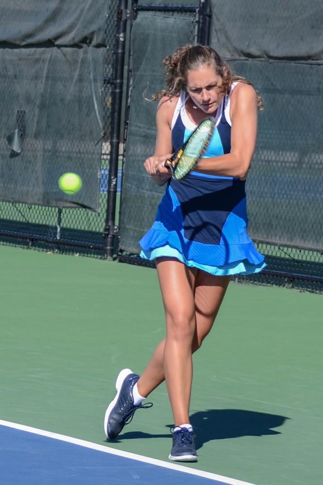 GVL / Hannah Mico. Senior Lexi Rice focuses hard on returning a volley at Saturday mornings match against Wayne State University; Rice was playing doubles with her partner Carola Orna (junior).
