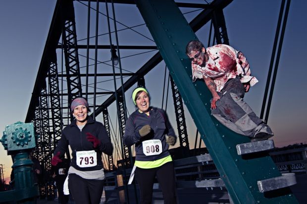 	Runners race along the Grand River at last year’s Zombie Dash.